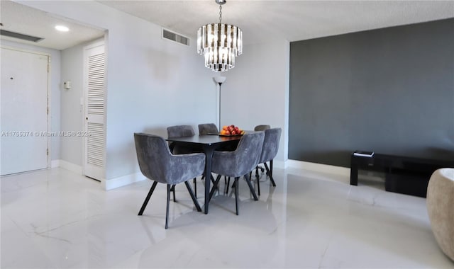 dining space featuring a chandelier, marble finish floor, visible vents, and baseboards