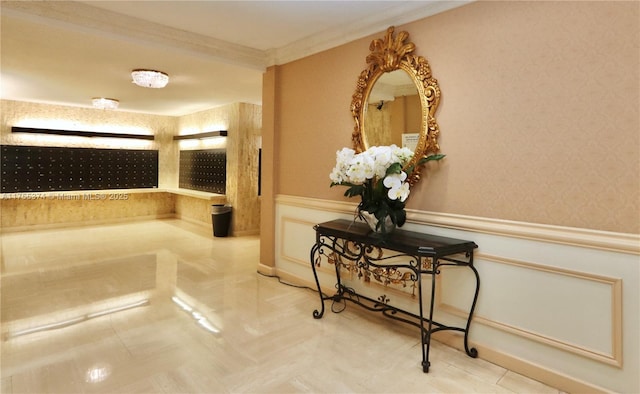 hall featuring ornamental molding, a wainscoted wall, and wallpapered walls