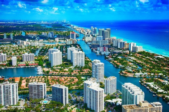 birds eye view of property with a water view and a city view