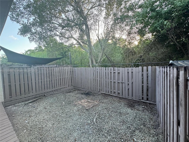 view of gate with a fenced backyard