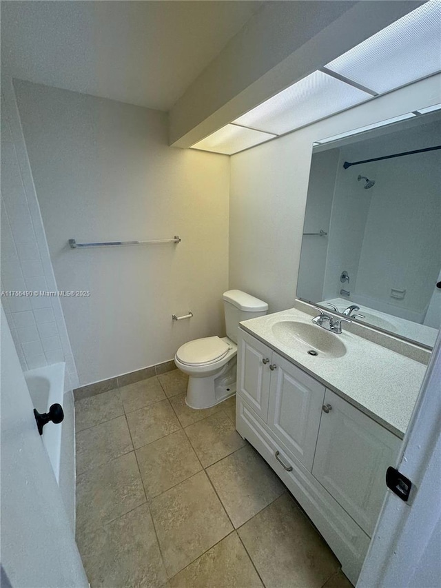 bathroom with toilet, tile patterned flooring, vanity, and baseboards