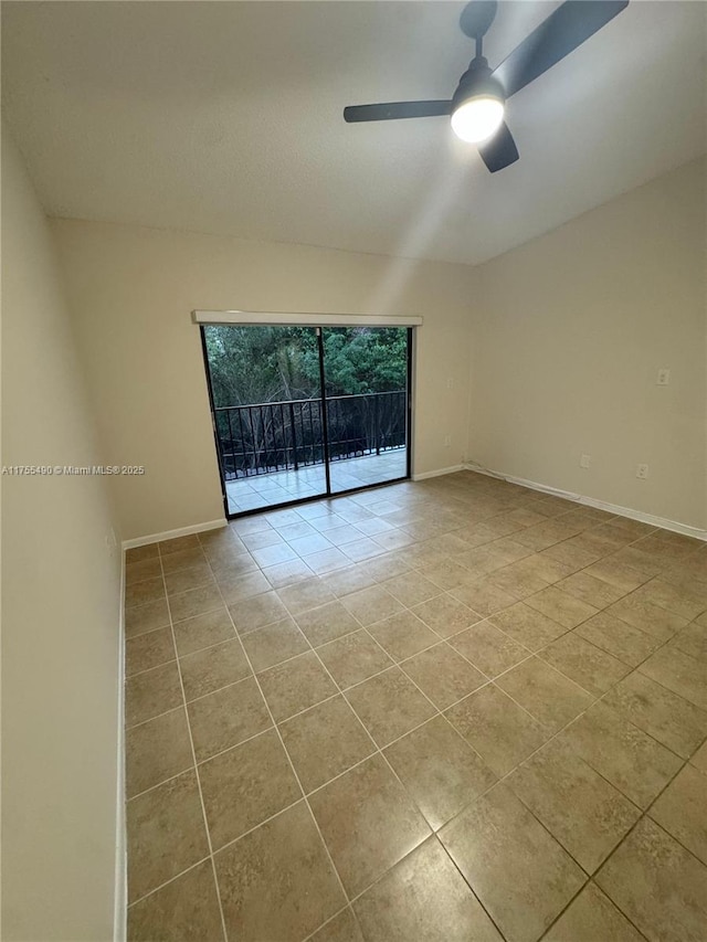 tiled spare room with ceiling fan and baseboards