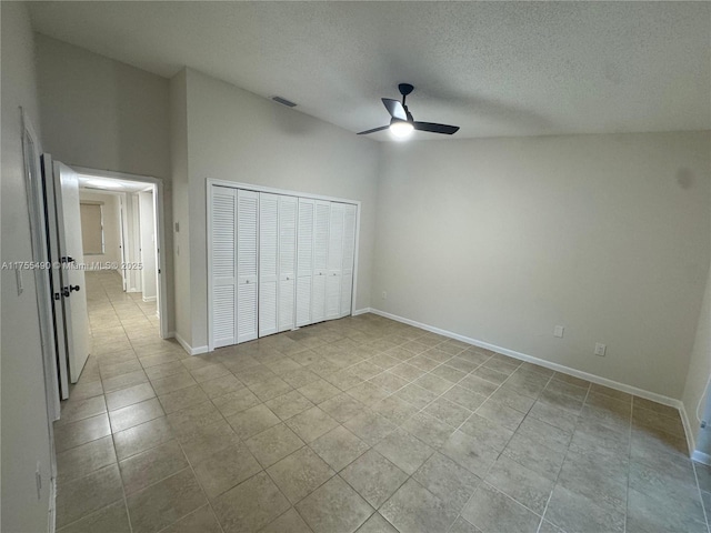 unfurnished bedroom with baseboards, visible vents, a ceiling fan, a textured ceiling, and a closet