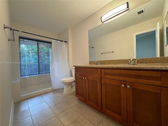 full bath featuring tile patterned floors, visible vents, toilet, and double vanity