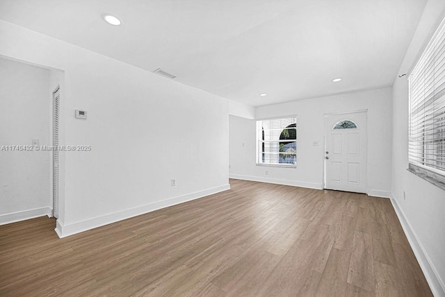 interior space with recessed lighting, wood finished floors, visible vents, and baseboards