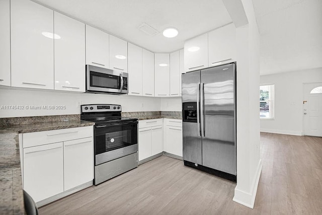 kitchen with white cabinetry, visible vents, appliances with stainless steel finishes, and light wood-style flooring