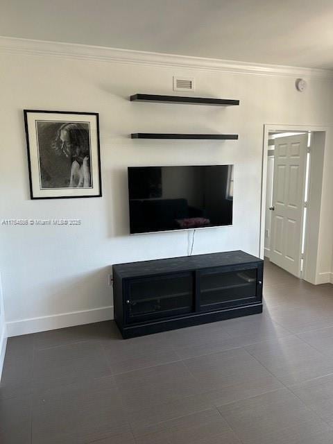 unfurnished living room featuring visible vents, crown molding, and baseboards