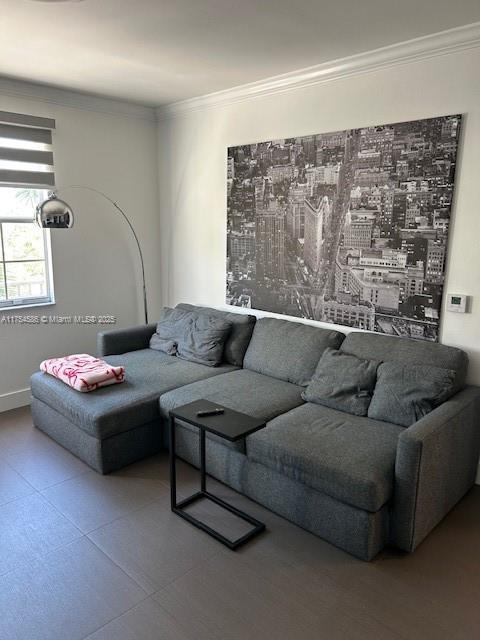 living area with crown molding