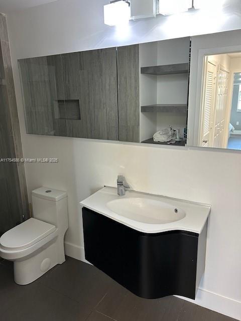 bathroom with toilet and vanity