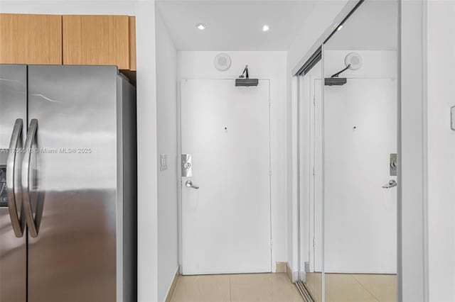 hallway featuring light tile patterned floors and recessed lighting