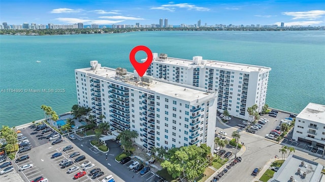 birds eye view of property with a water view and a city view