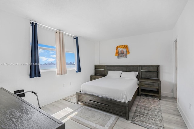 bedroom with wood finished floors and baseboards