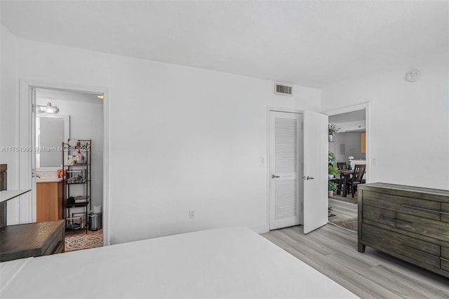 bedroom featuring visible vents and light wood-style flooring