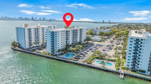 birds eye view of property with a water view and a city view