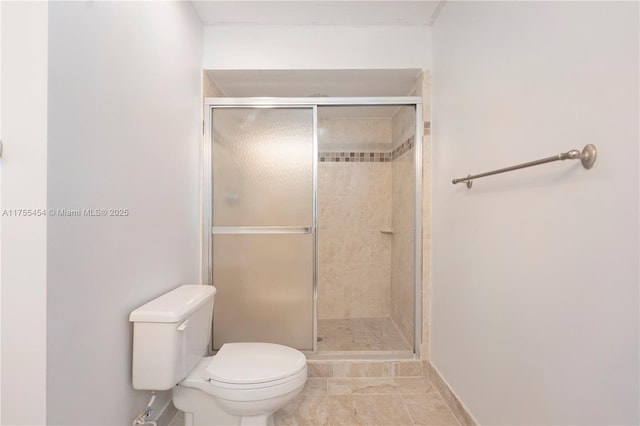 full bath featuring tile patterned flooring, a shower stall, and toilet