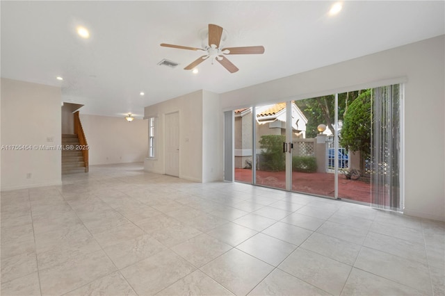 spare room featuring recessed lighting, a ceiling fan, baseboards, visible vents, and stairway