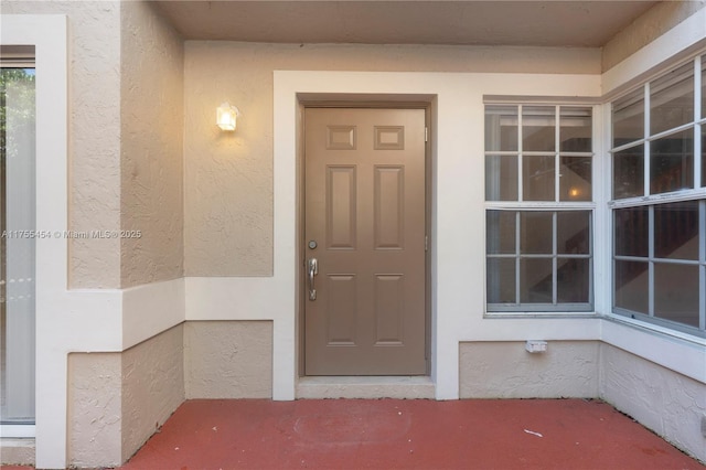 doorway to property with stucco siding