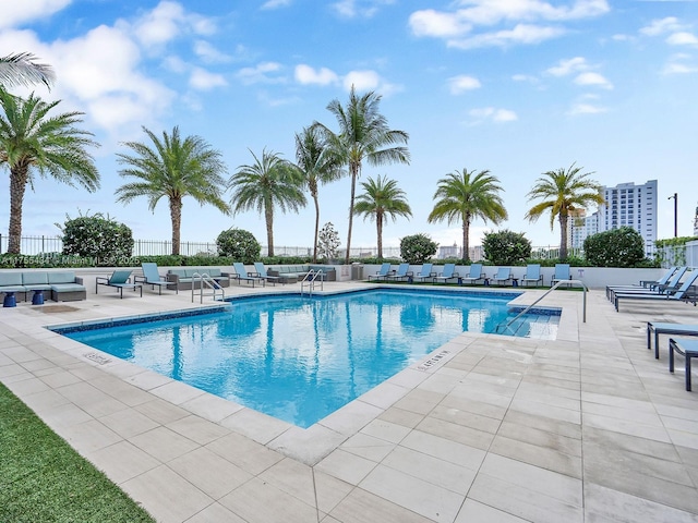 pool featuring a patio area and fence