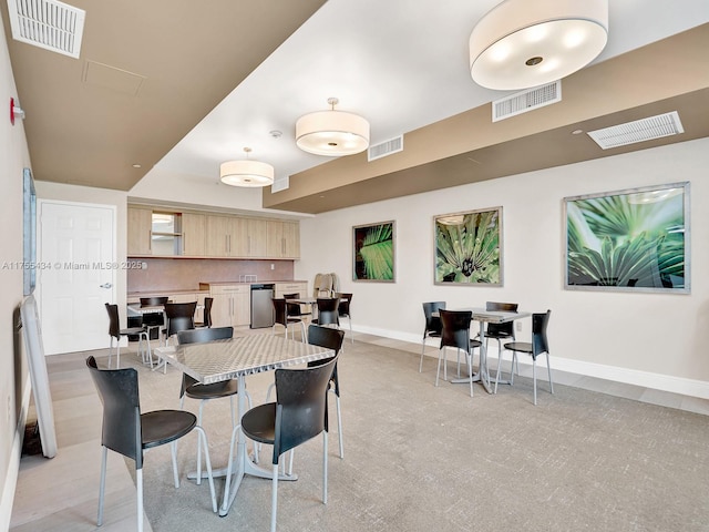 kitchen featuring light brown cabinets and visible vents