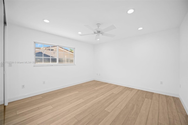 unfurnished room featuring light wood-type flooring, baseboards, and recessed lighting