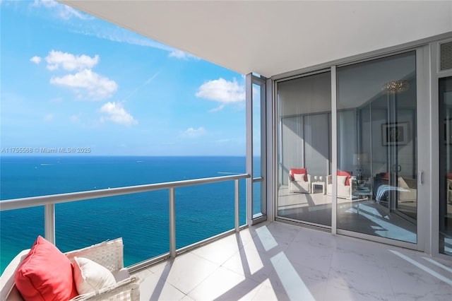 balcony with a water view and a sunroom