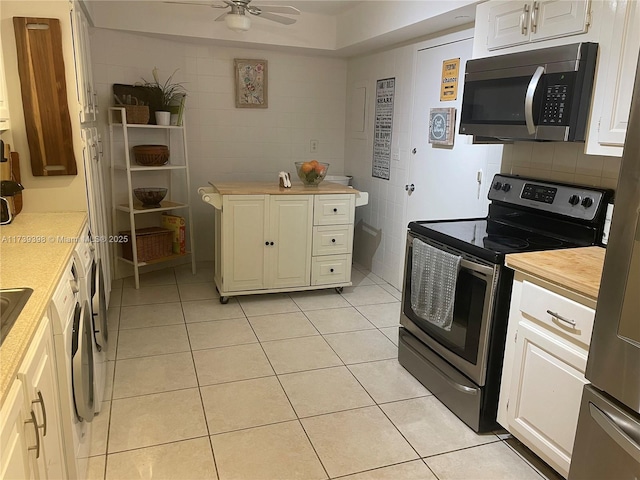 1121 Crandon Blvd Unit D404, Key Biscayne, FL 33149 - kitchen featuring ceiling fan, light tile patterned floors, white cabinetry, and stainless steel appliances