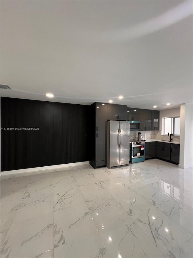 kitchen featuring stainless steel appliances, a sink, visible vents, marble finish floor, and light countertops