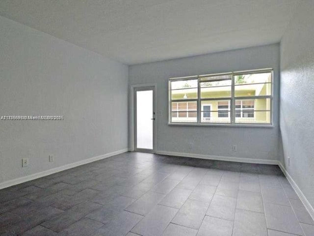 spare room featuring baseboards