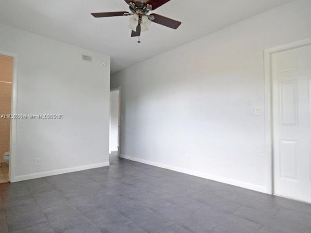 unfurnished room with ceiling fan, visible vents, and baseboards