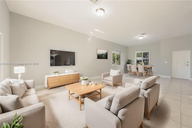 living room featuring light tile patterned floors and baseboards