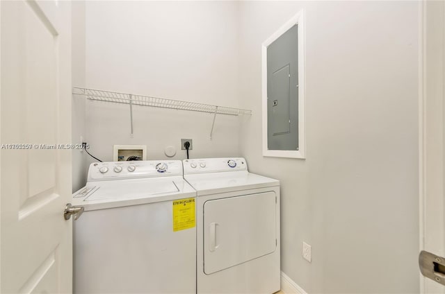 laundry area featuring laundry area, electric panel, and separate washer and dryer