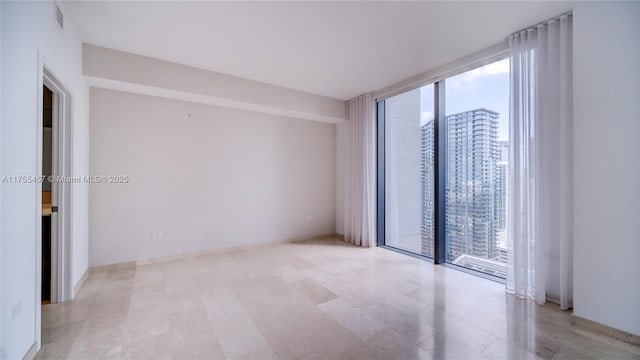 88 SW 7th St Unit 3003, Miami, FL 33130 - empty room with visible vents, a view of city, and a wall of windows