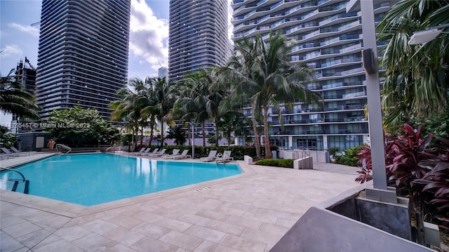 pool with a city view and a patio