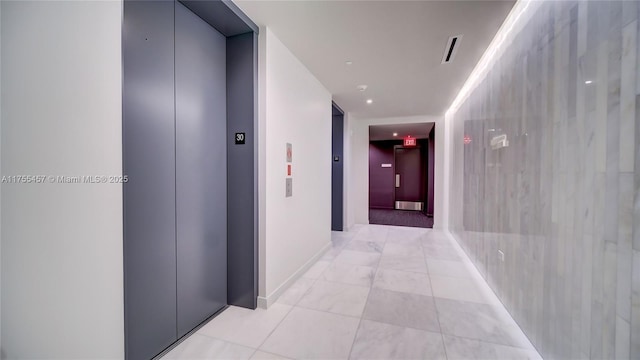 hall featuring elevator, light tile patterned floors, and visible vents