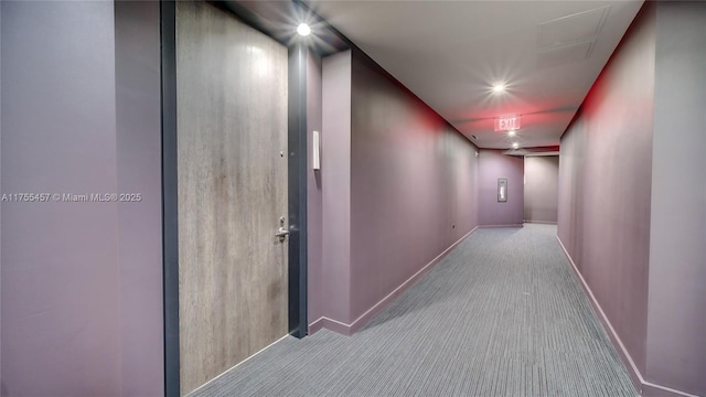 hallway featuring carpet floors and baseboards