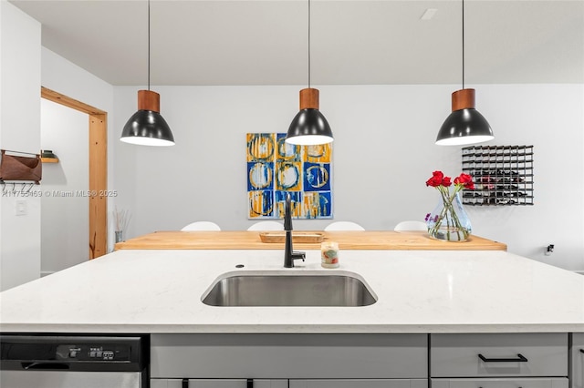 kitchen with dishwasher, decorative light fixtures, light stone countertops, gray cabinets, and a sink