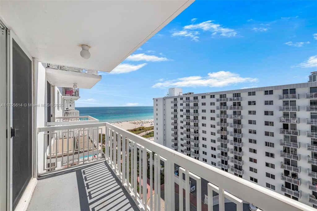 balcony with a view of the beach and a water view