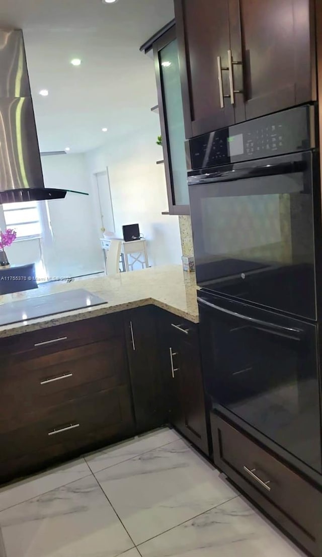 kitchen with light stone countertops, recessed lighting, black appliances, dark brown cabinetry, and marble finish floor