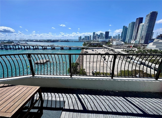 balcony with a water view and a city view