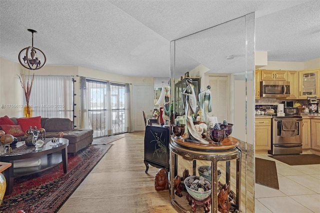 living room with a textured ceiling and light tile patterned flooring