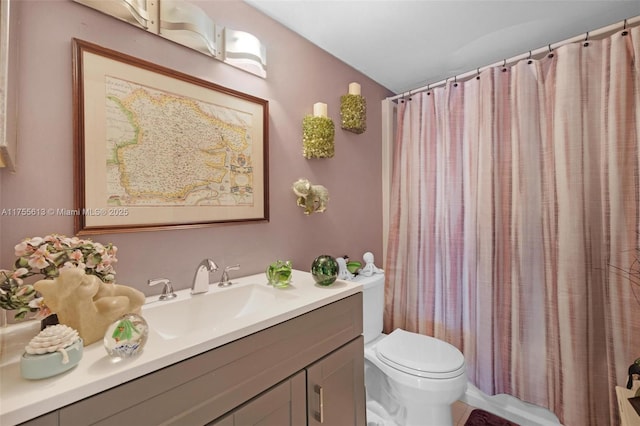 bathroom featuring vanity, toilet, and a shower with curtain