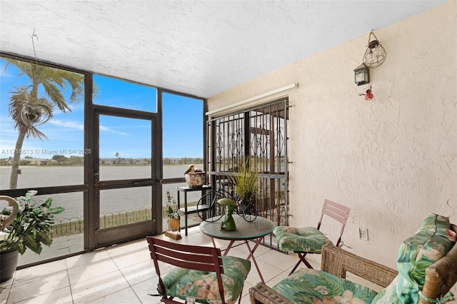 sunroom / solarium with a water view