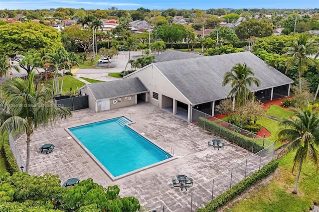 community pool featuring a patio area and a fenced backyard