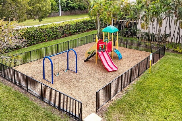 communal playground with fence and a lawn