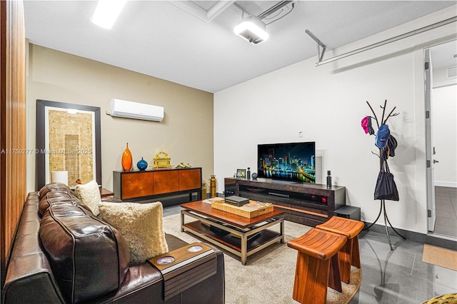 living area featuring a garage, an AC wall unit, and baseboards