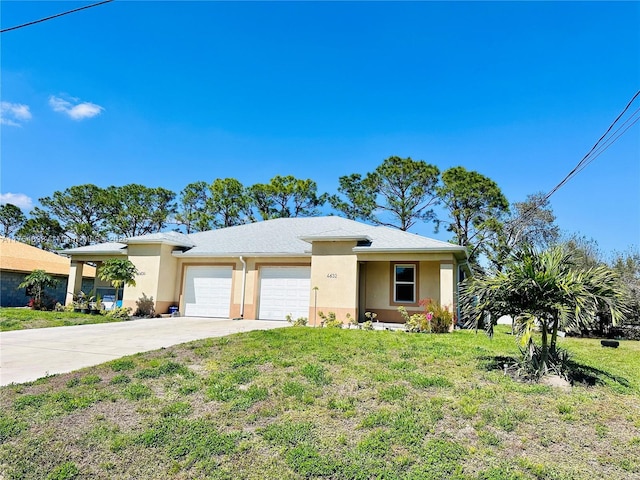 view of front of house featuring driveway, an attached garage, a front yard, and stucco siding