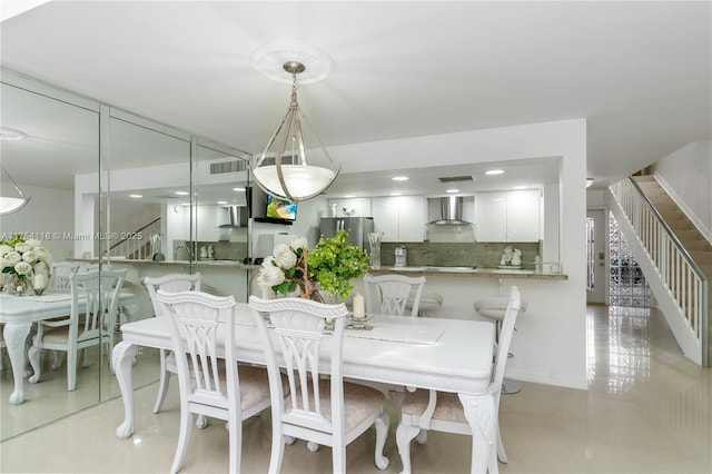 dining space featuring visible vents and stairway