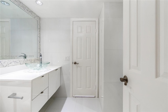 bathroom featuring tile patterned floors, tile walls, and vanity