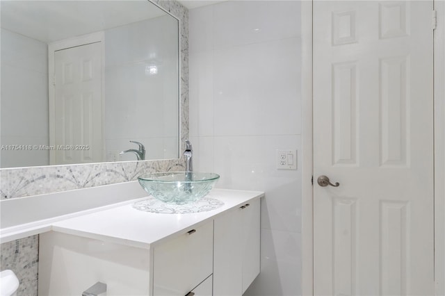 bathroom featuring tile walls and vanity