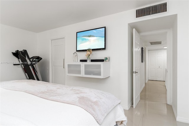 bedroom with baseboards and visible vents